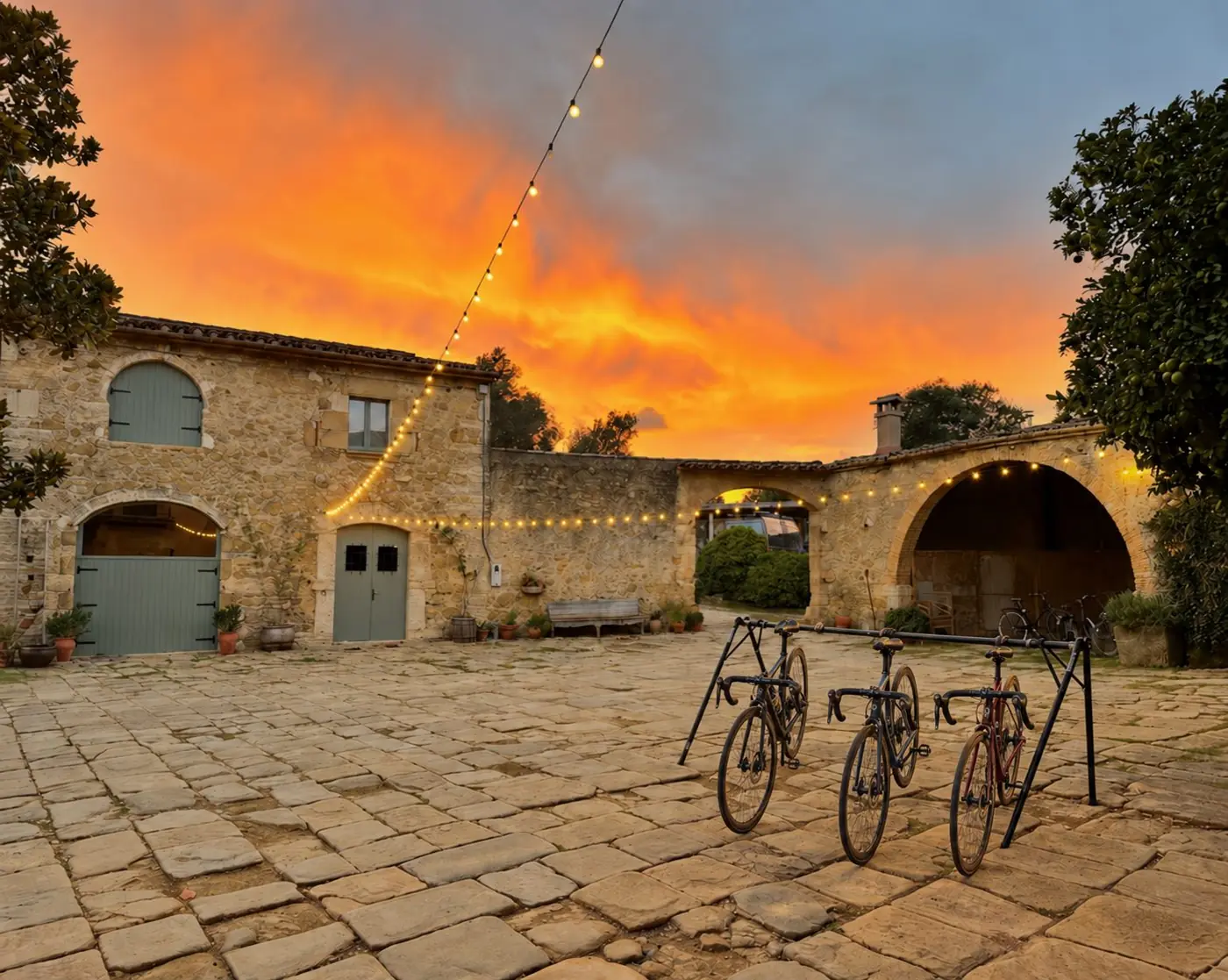 Road bikes in the courtyard at Can Campolier under the evening lights