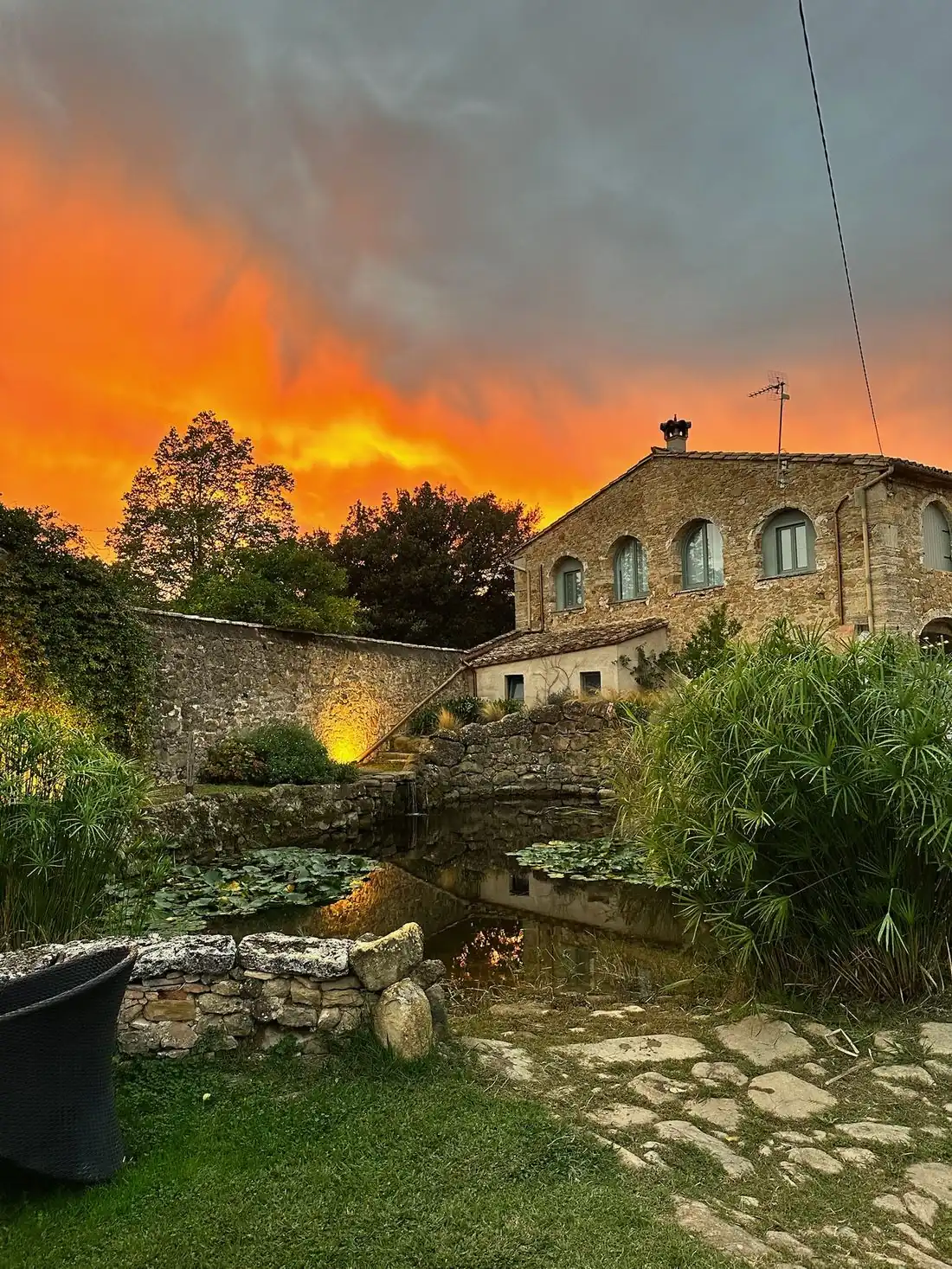 Can Campolier at sunset, across the lily pond